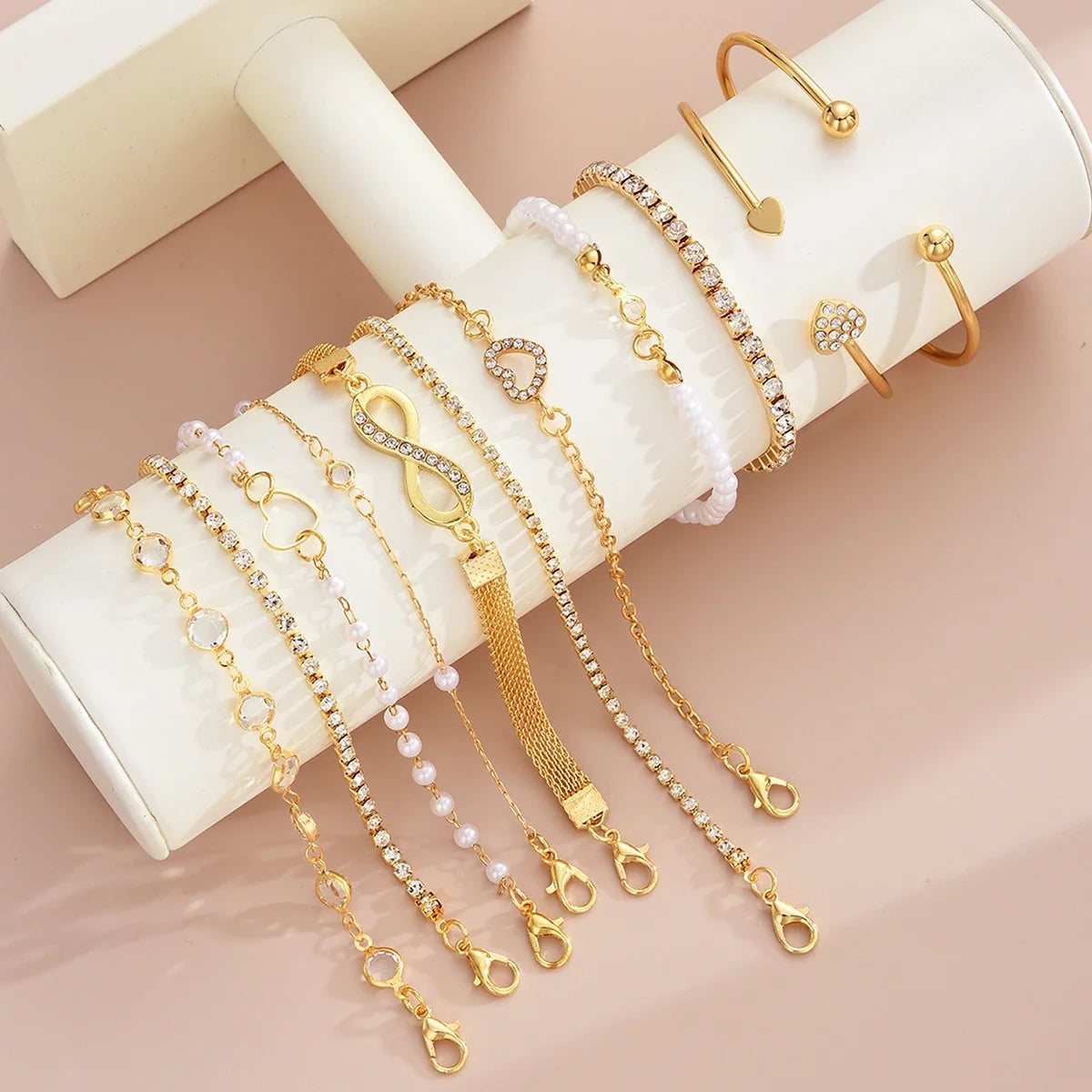 Amélie eleven-piece gold bracelet set on ivory display — detail 5