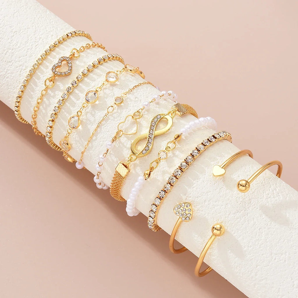 Amélie eleven-piece gold bracelet set on ivory display — detail 1