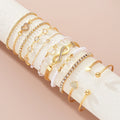 Amélie eleven-piece gold bracelet set on ivory display — detail 1