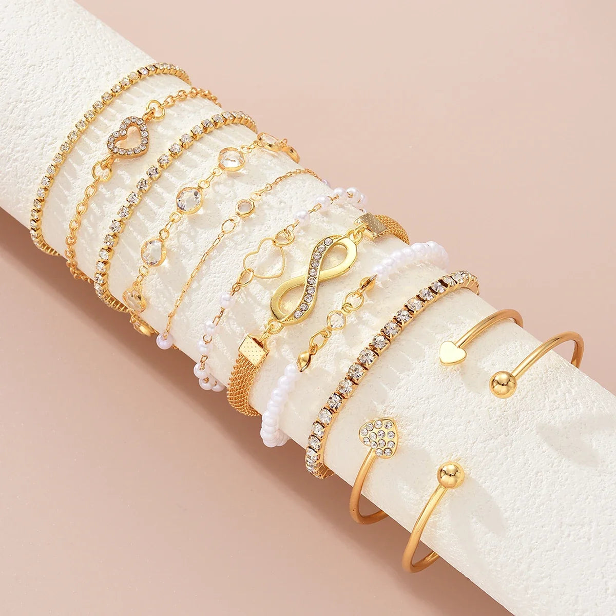 Amélie eleven-piece gold bracelet set on ivory display — detail 1