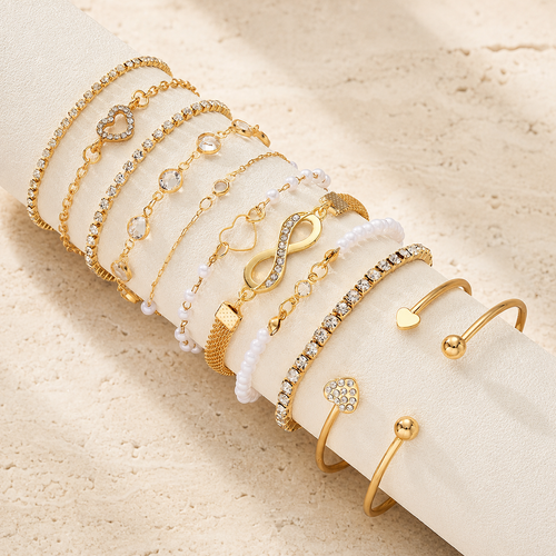 Amélie eleven-piece gold bracelet set on ivory display